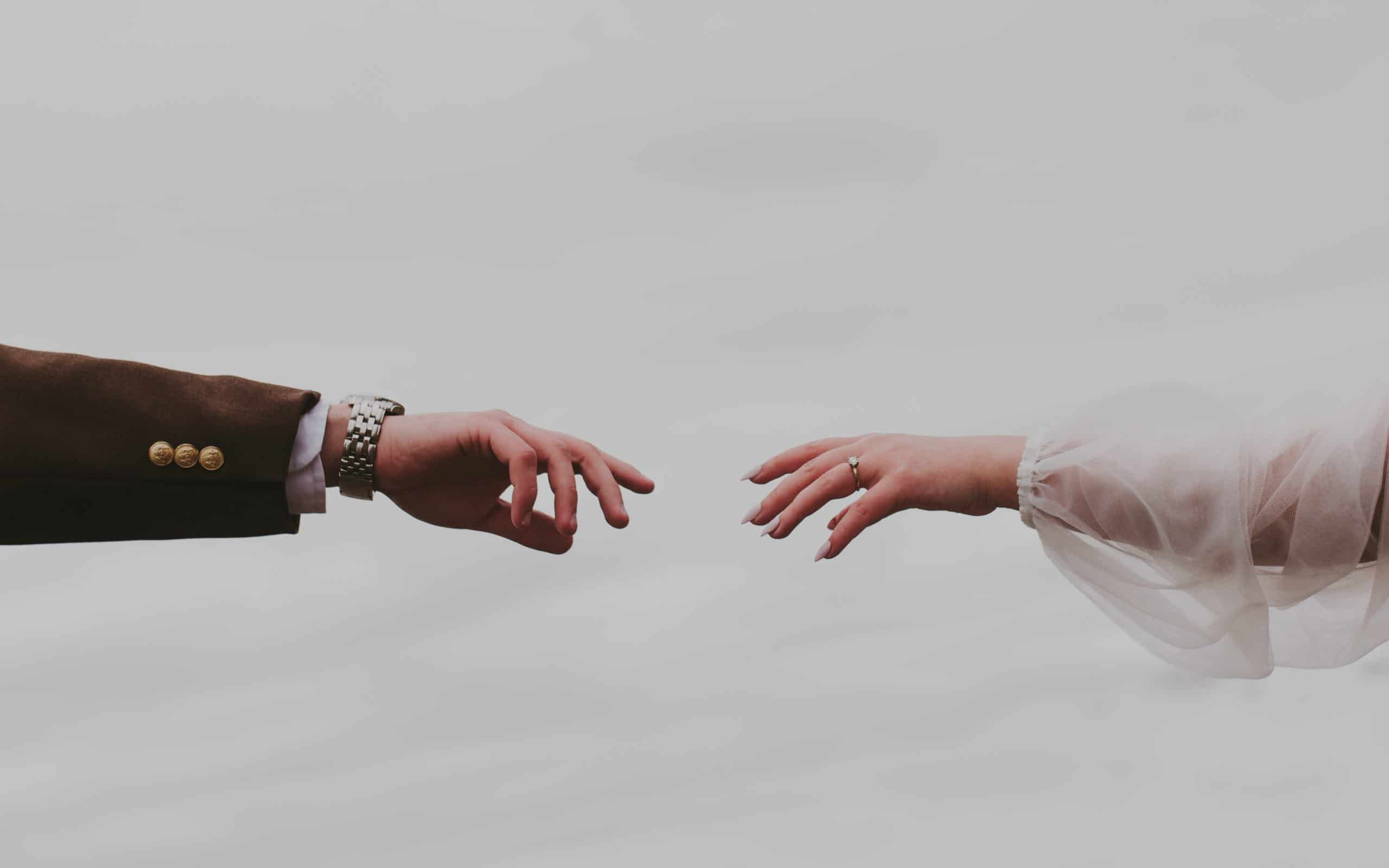 elopement couple reaching out toward each other