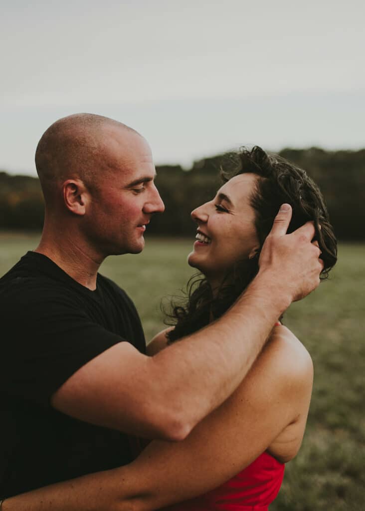 man in love pushing hair behind fiance's ear